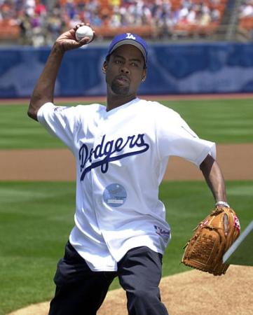 Comedian and actor Chris Rock, right, throws the ceremonial first pitch to open the game between the Los Angeles Dodgers and the Arizona Diamondbacks at Dodger Stadium in Los Angeles, Saturday, June 1, 2002. Rock also read Lou Gehrig's farewell speech to raise awareness about Amyotrophic Lateral Sclerosis (ALS), also known as Lou Gehrig's disease. Photo by Krista Niles