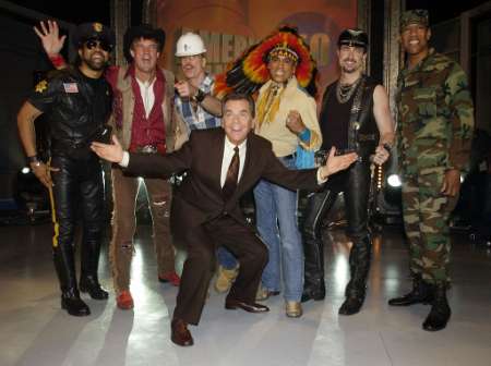 Host Dick Clark (C), poses for photographers with members of the Village People before the Disco group performed a medley of their hit songs during a taping of 'American Bandstand's 50th...A Celebration' in Pasadena, California, April 20, 2002. Photo by Jim Ruymen
