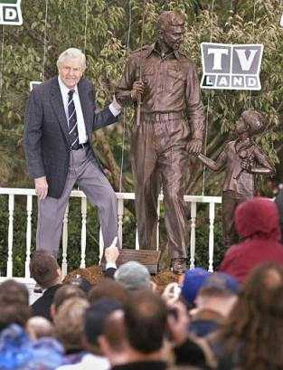 Andy Griffith stands next to a bronze statue of Andy and Opie from the 'Andy Griffith Show,' Tuesday, Oct. 28, 2003, during a ceremony in Raleigh, N.C. Photo by Bob Jordan
