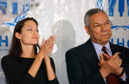 Secretary of State Colin Powell and actress Angelina Jolie, a United Nations High Commission for Refugees' goodwill ambassador, applaud during a World Refugee Day event, Thursday, June 20, 2002 at Union Station in Washington.  Photo by Evan Vucci