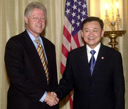 Former U.S. President Bill Clinton, left, shakes hand with Thailand Prime Minister Thaksin Shinawatra at the Government House in Bangkok on Saturday, May 25, 2002. Clinton is on a private visit to Thailand. Photo by Sakchai Lalit
