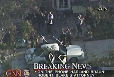 In this image from television, actor Robert Blake, left center near the car wearing white shirt, is seen being placed into a police vehicle Thursday, April 18, 2002, in Los Angeles, according to CNN. Authorities arrested Blake for the shooting death of his wife Bonny Lee Bakely nearly a year ago, his attorney said. (AP Photo/CNN, Courtesy of KTTV)