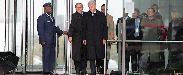 Resident Bush and former President Bill Clinton squeezed through the glass entrance to the library.   Photo by Fred R. Conrad