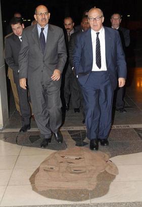 Hans Blix, U.N. chief inspector, right, and Mohammed ElBaradei, head of the International Atomic Energy Agency, step on a mosaic of former U.S. President George Bush in the doorway of Baghdad's Al-Rashid Hotel Monday, Nov. 18, 2002. U.S. troops visited the hotel Thursday night, April 10, 2003, and dug out the mosaic doormat, which has served as a state-sponsored insult since 1991. Photo by Hussein Malla