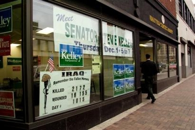 A service member returns to the U.S Army recruitment center in Duluth, Minn., Wednesday, Dec. 28, 2005, next door to Steve Kelley for Governor campaign offices. Scott Cameron, a veterans' advocate and volunteer on Kelley's gubernatorial campaign, has attracted attention for placing the sign keeping a running count of American casualties in Iraq in the window. Photo by Julia Cheng