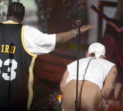 Rapper Eminem moons the audience during taping of the MTV Movie Awards show in Culver City, Calif., Saturday, June 5, 2004. The scene will be edited-out of the final version of the show to air June 10. At left is an unidentified member of the band. Photo by Chris Pizzello