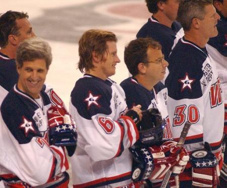 Celebrity hockey players from left, U.S. Sen John Kerry, D-Mass., actors/comedians Denis Leary and Rick Moranis and former Boston Bruins' Chris Nilan, right, suit up to play a charity game against a team of Boston Bruins all-stars for the Leary Firefighters Foundation in Worcester, Mass., Sunday, Sept. 29, 2002. Leary founded the organization following the death of six Massachusetts firefighters, including his cousin, Jeremiah Lucey, in a December 1999 blaze in Worcester. Photo by Neal Hamberg