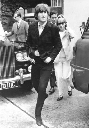 Beatle John Lennon and his wife, Cynthia, arrive late for a news conference at Twickenham Studios, Middlesex, England, on June 12, 1965. The Beatles have been created members of the Most Excellent Order of the British Empire in the Queen's birthday honors list. Behind the couple at center is the band's manager Brian Epstein