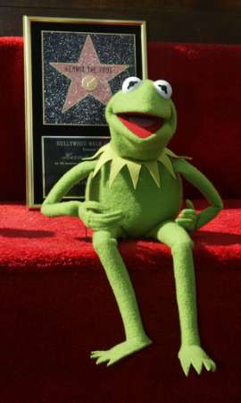 The most popular Muppet of all time, Kermit the Frog, poses with a plaque November 14, 2002 in Hollywood after receiving his own star on the Hollywood Walk of Fame. Kermit received the plaque in honor of his career in television, movies and music. Photo by Fred Prouser