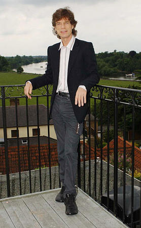 Rolling Stone Mick Jagger poses at his home in southwest London, Friday, June 14, 2002, before it was announced that he has received a knighthood in the Queen's Birthday Honours List. Photo by MJ Kim