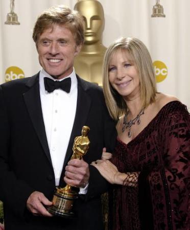 Robert Redford and Barbra Streisand pose for photographers with