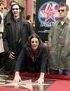 Ozzy touches his star. Posing with Osbourne are Marilyn Manson (L) and Robbie Williams. Photo by Jim Ruymen