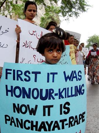 A Pakistanis girl takes part in a protest against a gang rape, Wednesday, July 3, 2002 in Karachi, Pakistan. Pakistan's Mastoi tribal council ordered a18-year-old girl from the lower class Gujar tribe girl to be raped by four men as a punishment to her family after her 11-year-old brother was seen walking with a Mastoi girl, police said Tuesday. Photo by Mohammed Sabir