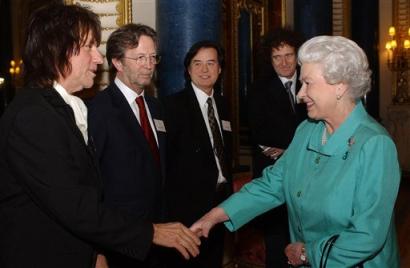 Britain's Queen Elizabeth II greets Jeff Beck, watched by, from second left, Eric Clapton, Jimmy Page, and Brian May of Queen, during a reception she hosted at Buckingham Palace in London, Tuesday 1 March 2005. The all-star gathering for major names in the music business, was a royal tribute to Britain's music industry. Photo by Kirsty Wigglesworth