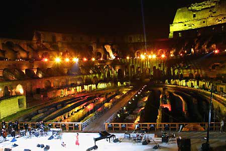 Rome's Colosseum, illuminated, is seen during the concert as artists from all over the world performed songs promoting peace and equality, with particular emphasis on the Middle East conflict. Photo by Vincenzo Pinto