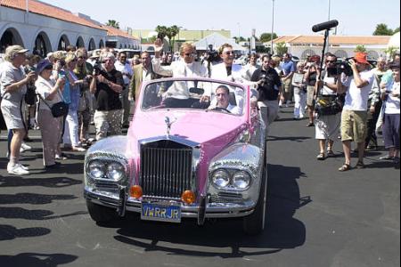 Las Vegas entertainers Siegfried and Roy ride in the back of a 1971 Volkswagen, altered to resemble a Rolls Royce, once owned by Liberace and used in his performances, as they make their way through the crowd as the guests of honor to celebrate the opening of the new Liberace Museum in Las Vegas on Thursday, May 30, 2002. The car is covered in mirrored tiles. Photo by Jeff Klein