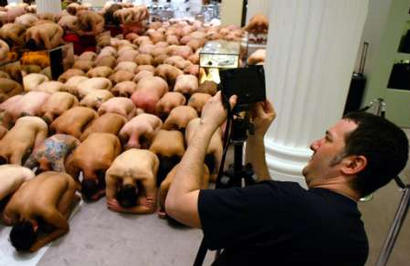 New York artist Spencer Tunick sets his camera as he photographs naked volunteers during his 'Be Consumed' installation at Selfridge's department store in London April 27, 2003. Around 600 volunteers posed naked for Tunick's Body Craze in the store. Photo by John Pryke