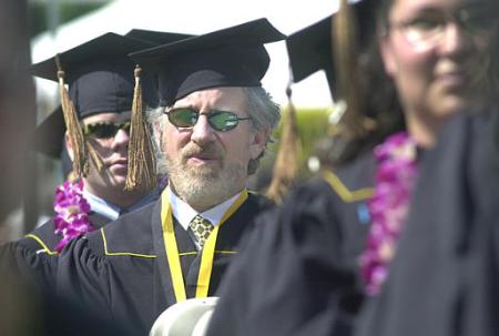 Oscar-winning director Steven Spielberg, center, sits among fellow graduates during commencement ceremonies at California State University, Long Beach, Friday, May 31, 2002, in Long Beach, Calif. Photo by Nick Ut
