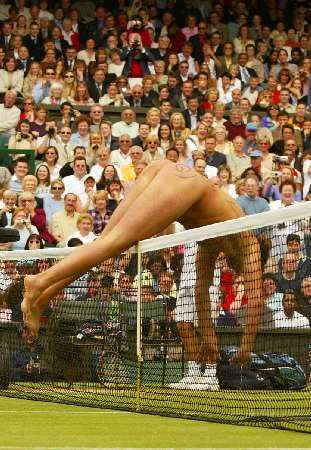 A streaker dives over the net during the men's singles final between Argentina's David Nalbandian and Australia's Lleyton Hewitt at the Wimbledon tennis championships, July 7, 2002. Photo by Ian Hodgson