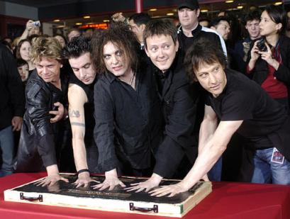From left, Jason Cooper, Simon Gallup, Robert Smith, Roger O'Donnell and Perry Bamonte of British rock group The Cure put their hands in cement at Hollywood's Rockwalk in Los Angeles, Friday, April 30, 2004. Photo by Chris Pizzello