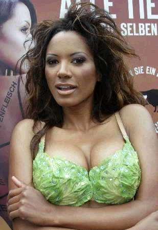 Former Baywatch star and Playboy model Traci Bingham poses for cameras with a bikini made of fake lettuce leaves to promote vegetarianism outside a Berlin steakhouse July 18, 2002. Photo by Fabrizio Bensch