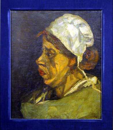 A painting named 'Peasant Woman,' confirmed as a work by Dutch impressionist Vincent Van Gogh, is displayed for auction at an art gallery in Tokyo, February 7, 2003. The 16.3 inch by 13.7 inch oil painting, valued at about $85 prior to the investigation by the Van Gogh museum in Amsterdam, will be auctioned on Saturday for a starting price of $25,000, according to the Shinwa Art Gallery. Photo by Yuriko Nakao