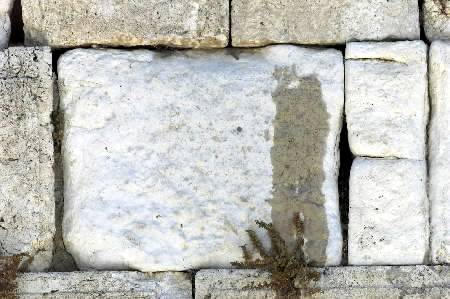 Moisture covers a stone of the Wailing Wall in Jerusalem July 4, 2002. A wet patch has appeared on the Western Wall of Jerusalem's Old City, inspiring some Jewish mystics to interpret it as a sign the messiah is coming and causing archaeologists to fret over faulty plumbing. An archaeologist for the Israel Antiquities Authority said it could be a leak but the authority has yet to discuss the patch with Islamic authorities who administer a mosque complex on a broad plaza supported by the wall holy to Judaism. Photo by Nir Elias